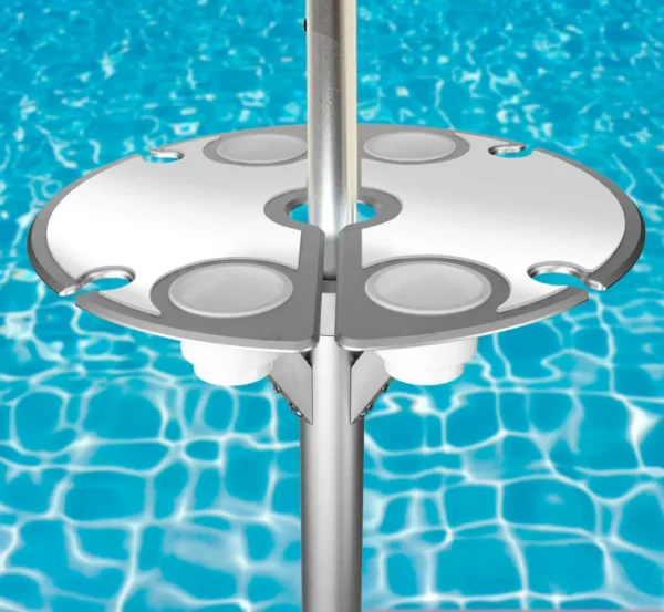 Vibrant BajaMate silicone placemats in blue, red, and beige displayed on a 24" aluminum entertainment table, designed to reduce heat and protect surfaces, arranged neatly on a baja shelf with a sparkling pool in the background.
