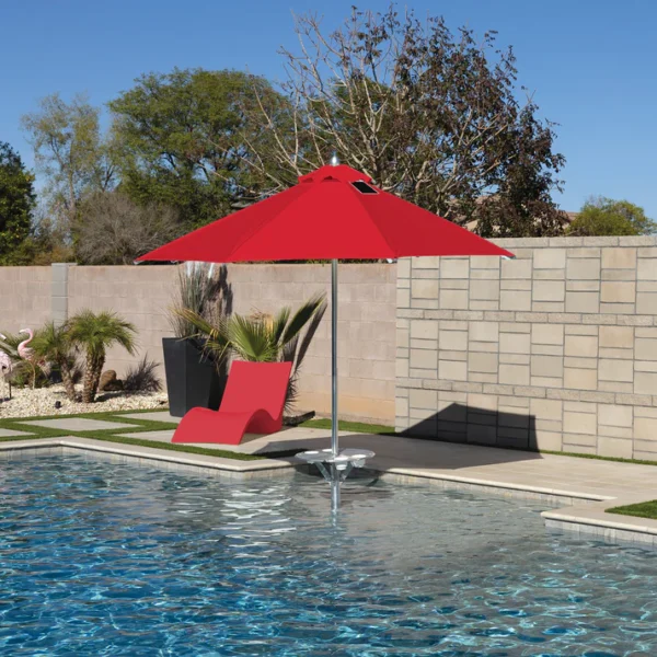 Close-up of a BajaMate Umbrella with a 2" silver aluminum pole and UV-resistant fabric in vibrant blue, showcasing its heavy-duty stainless steel crank mechanism and integrated 20-watt solar panel with a micro USB charging port for poolside use. The red umbrella
