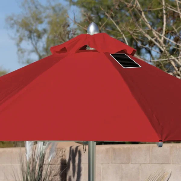 Close-up of a BajaMate Umbrella with a 2" silver aluminum pole and UV-resistant fabric in vibrant blue, showcasing its heavy-duty stainless steel crank mechanism and integrated 20-watt solar panel with a micro USB charging port for poolside use. The red umbrella